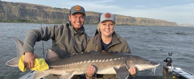 a man and a woman holding a fish