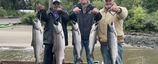 three men holding their catch fish while fishing in portland-oregon